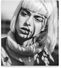 Model with modern blonde bob haircut styled at Grand Salon