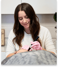 Licensed esthetician performing a facial at Grand MedSpa in Denver
