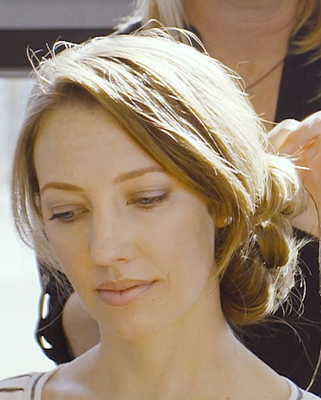 Stylist blow-drying and styling a client’s hair at Grand Salon in Denver